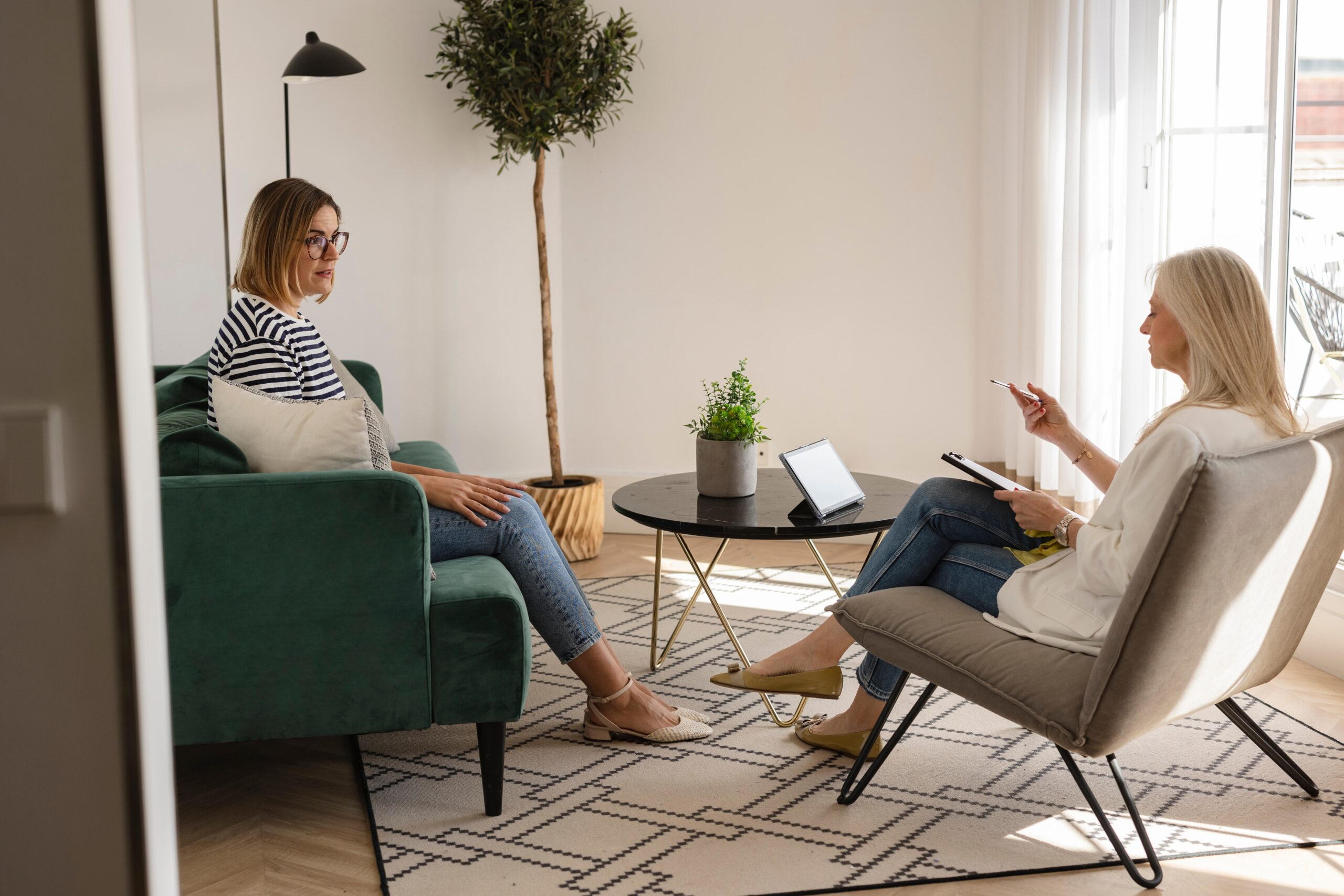 Two people in therapy session conversing with empathy Recognizing signs of emotional relapse in recovery with professional support