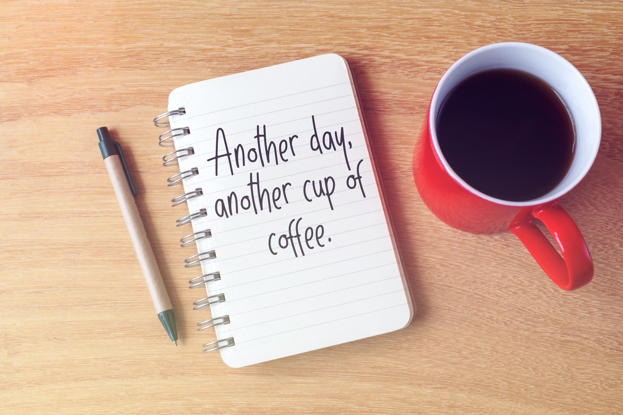 Open journal with handwritten quotes beside a cup of coffee inspiring sobriety quotes for motivation and recovery