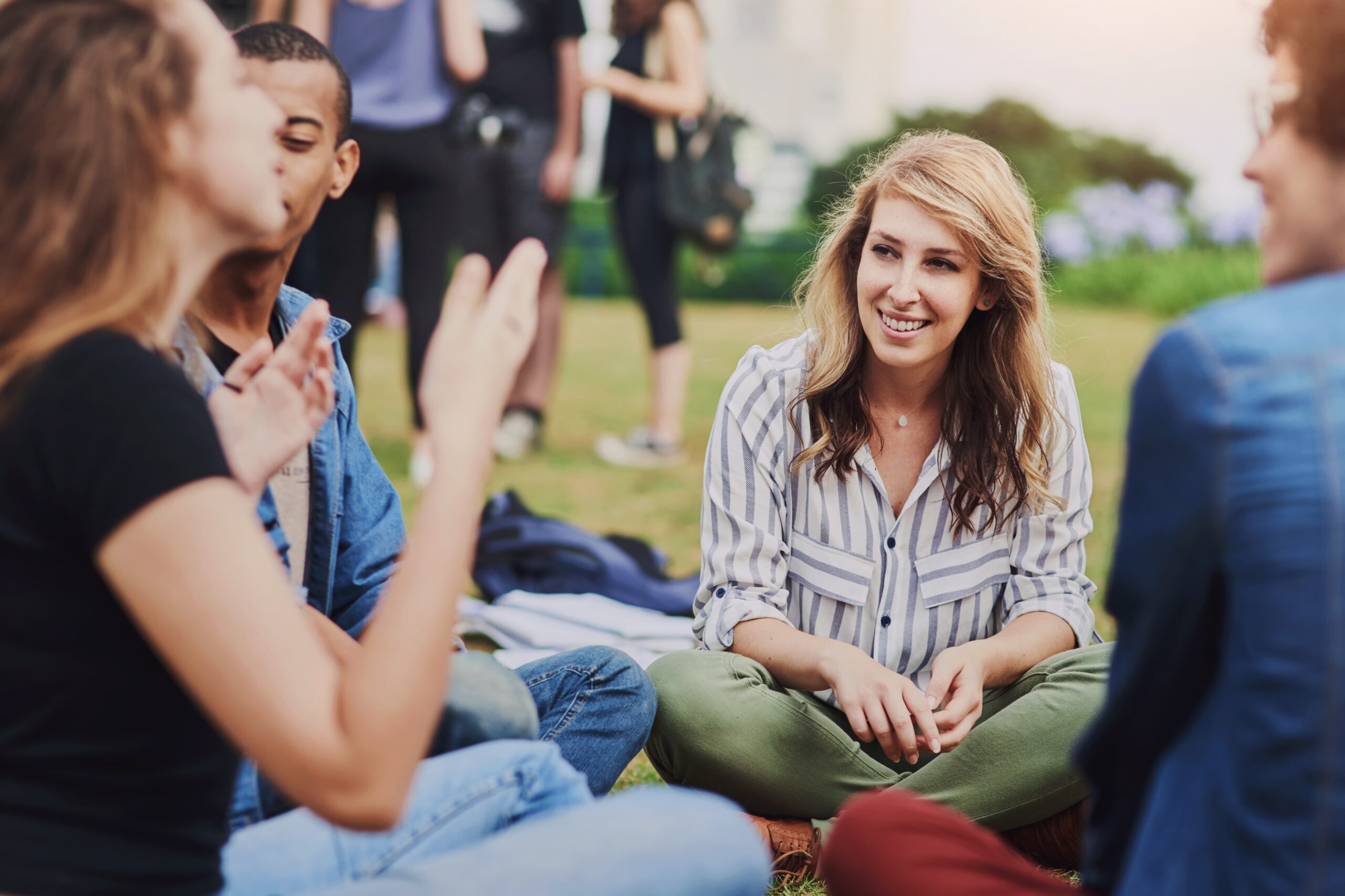 Group of young adults discussing addiction risks and support options