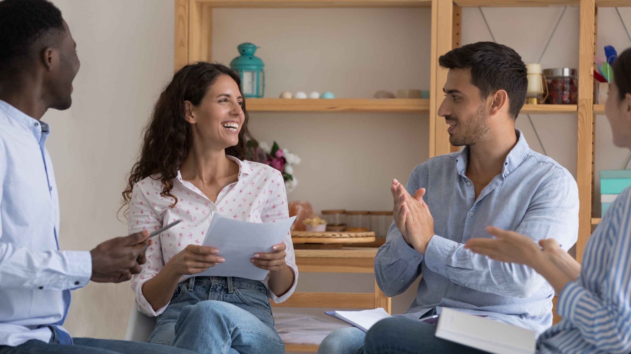 Two people in discussion, smiling and supportive, in a recovery center environment Inspire Recovery Center sponsor mentoring participant