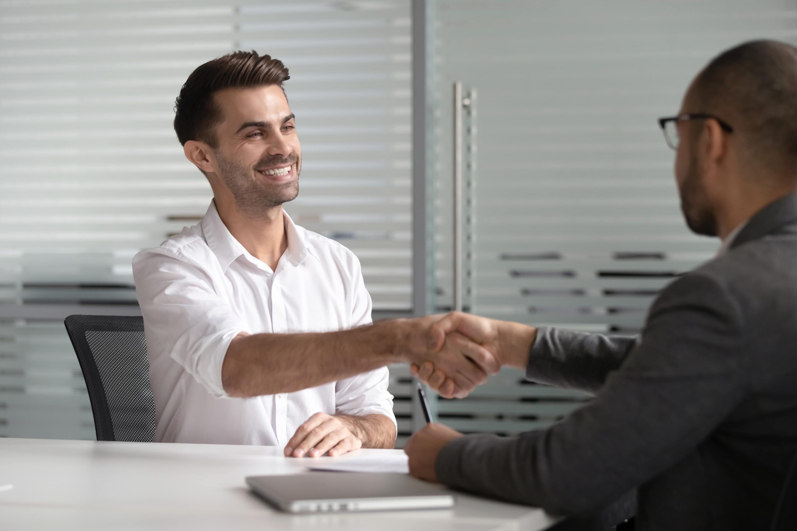 Professional person in recovery successfully explaining employment gap during a job interview.