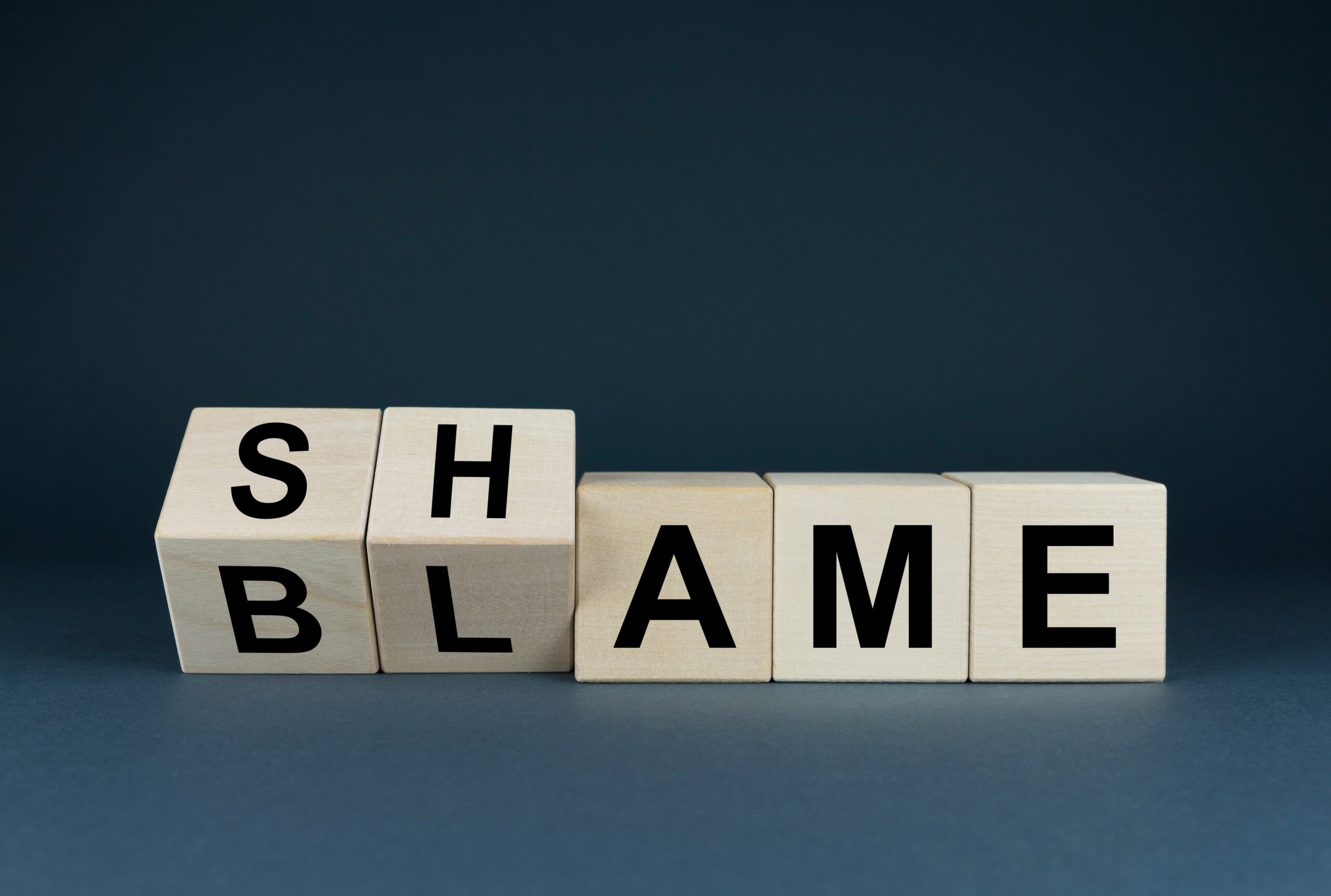 Visualizing the heavy burden of shame being lifted in mental health recovery.